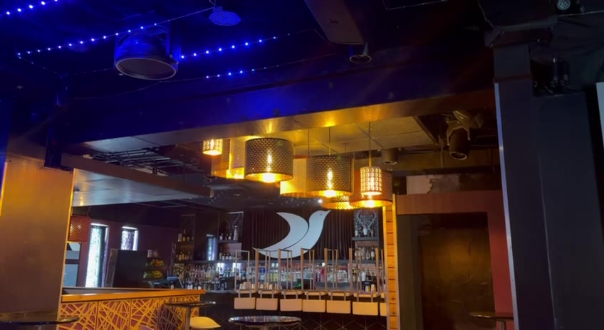 Chandeliers over the bar, lit